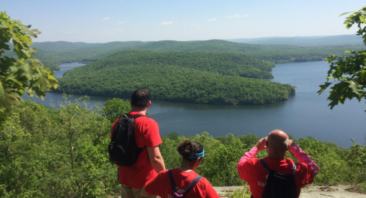 Hikers enjoy a scenic overlook of a lake in Norvin Green State Forest. Photo by Peter Dolan.