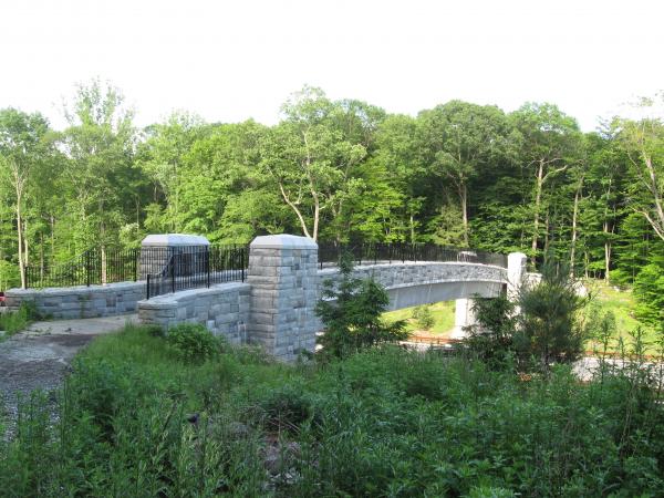 This pedestrian bridge over the Taconic State Parkway, connects the Yorktown Trailway with Legacy Fields/Woodlands Park and is a crucial link in a planned new community trail network.